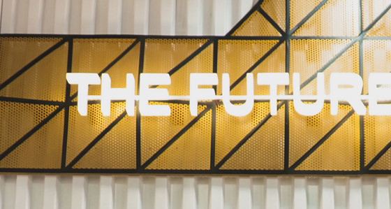 An illuminated sign with the slogan 'The Future Is Now'