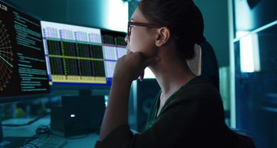 A Woman at a screen with data