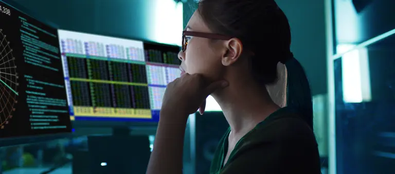A Woman at a screen with data