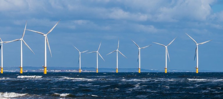 An offshore windfarm surrounded by a choppy sea