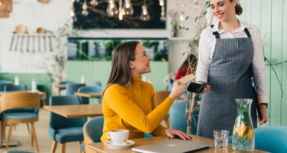 Woman paying for coffee with phone