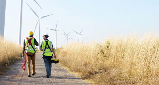 Workers walking along an onshore windfarm