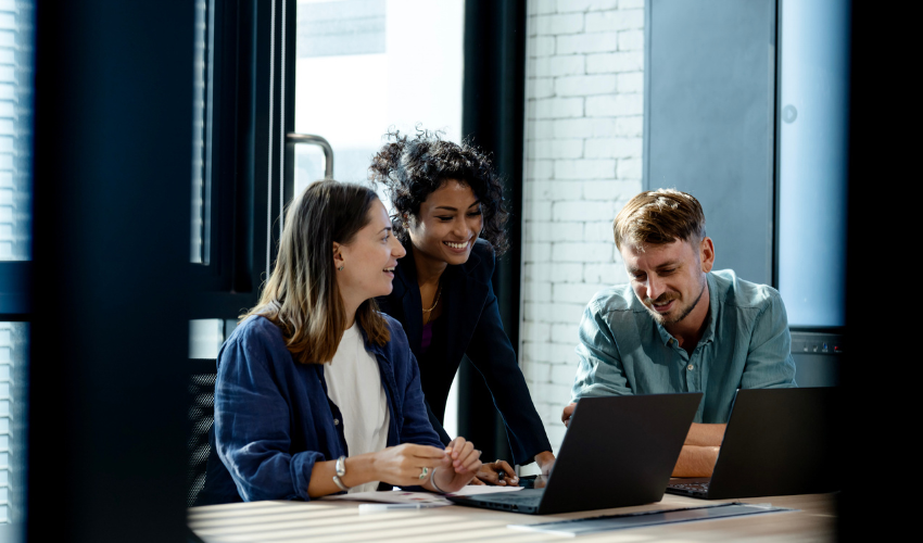Office workers looking at a laptop