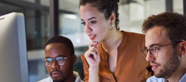 People in an office looking at a screen