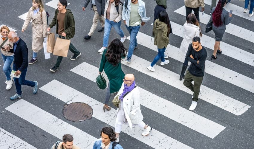 Overhead view of pedestrians crossing a busy city street