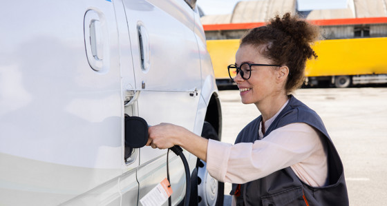 Woman charging her electric vehicle