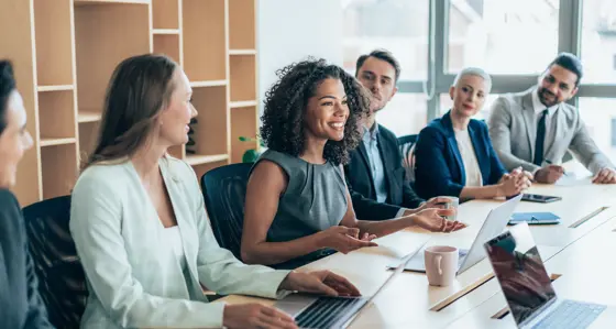 A woman smiling in a meeting