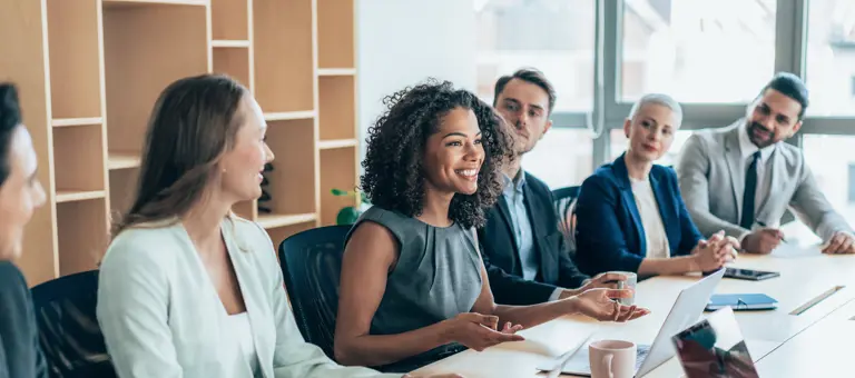 A woman smiling in a meeting