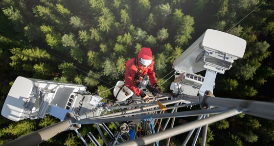 Worker climbing a communications tower