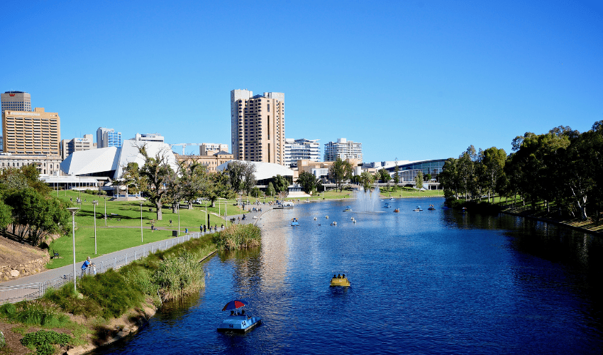  River Torrens in Adelaide with the Festival Centre and city skyline under a clear blue sky.