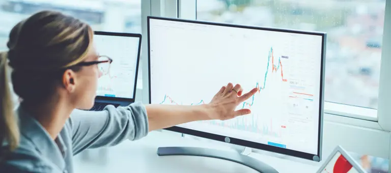 Woman pointing at chart on screen