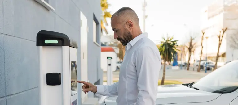 Man using an EV charger