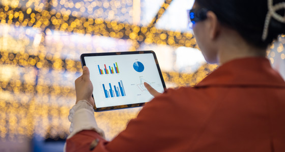 A person looking at data on a tablet