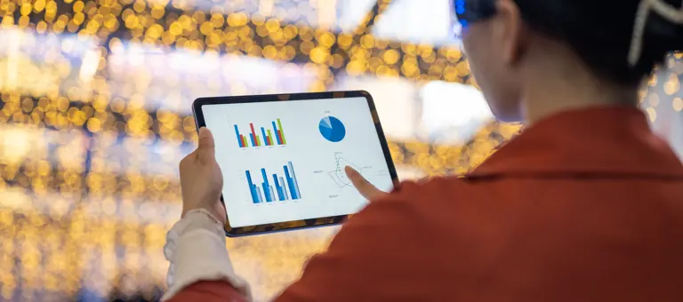 A person looking at data on a tablet