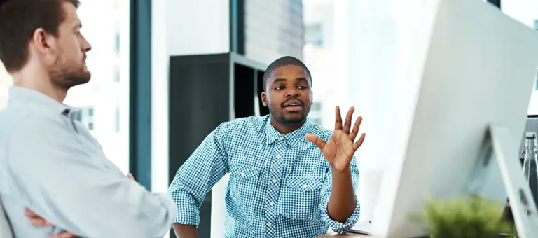 Two people looking at a computer
