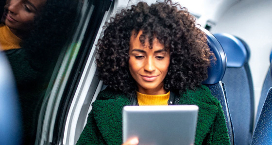 A woman sitting on the train looking at her phone