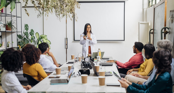 Group of people listening to a presenter in a meeting room