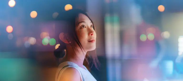 Young woman looking at futuristic digital display
