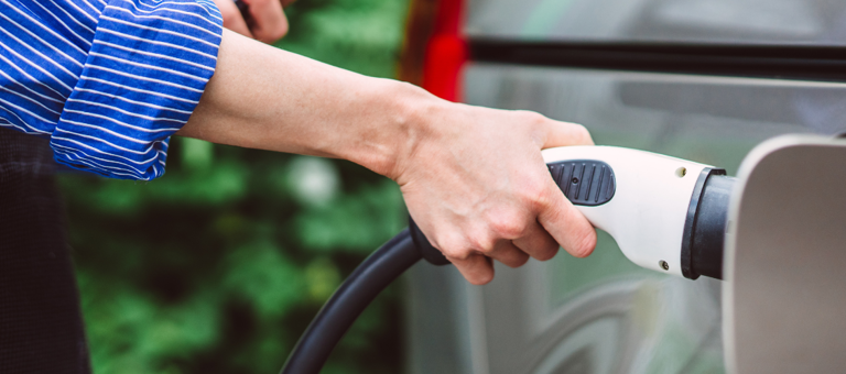 Woman charging an electric car