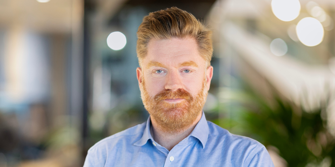 A professional headshot of Peter Thompson