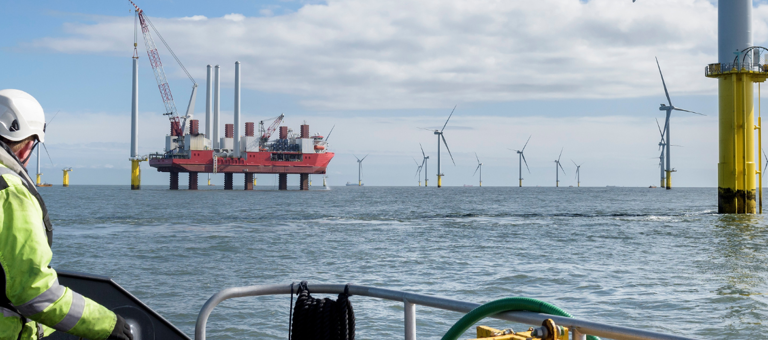 Man on a boat looking at an offshore facility