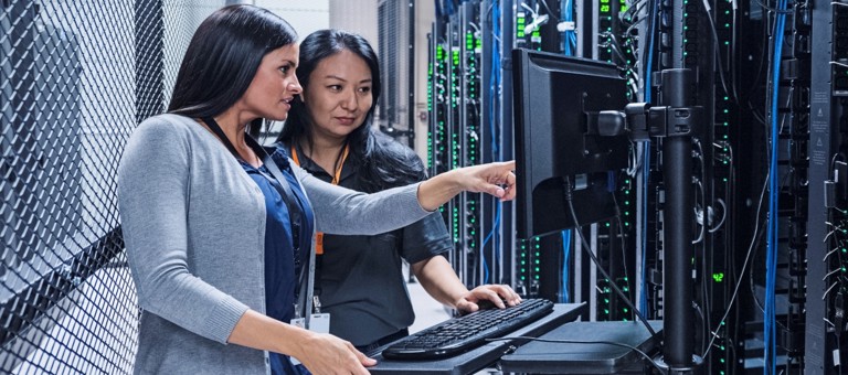 Women looking at a screen in a data centre