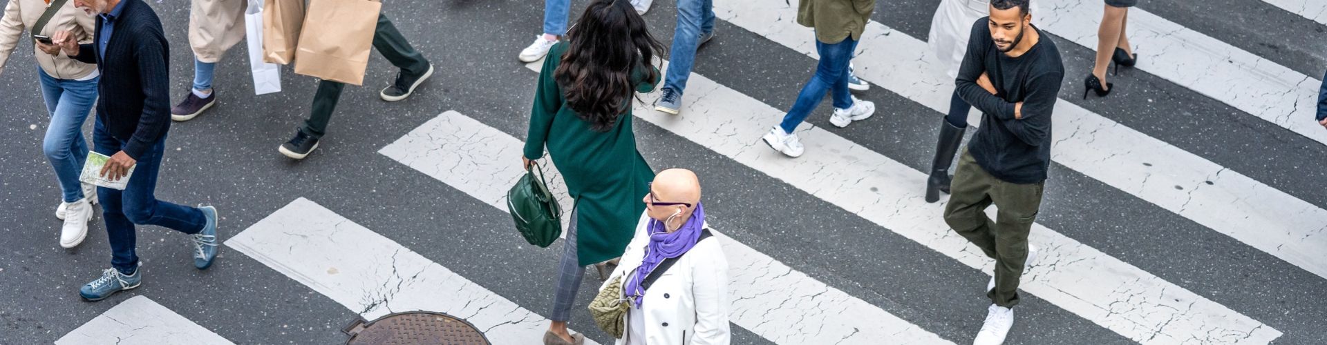 Overhead view of pedestrians crossing a busy city street