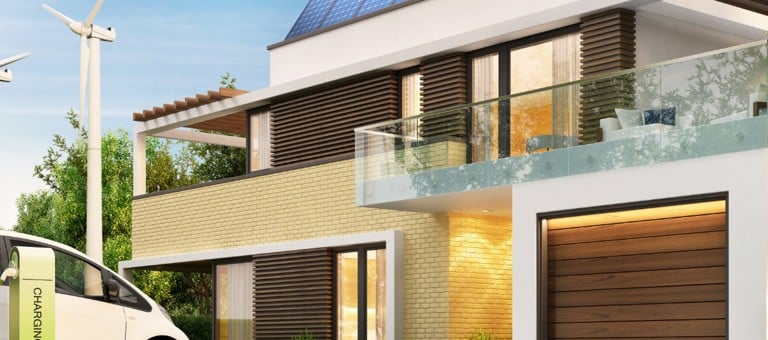 A modern home with solar panels, wind turbines in the garden and an electric car charging
