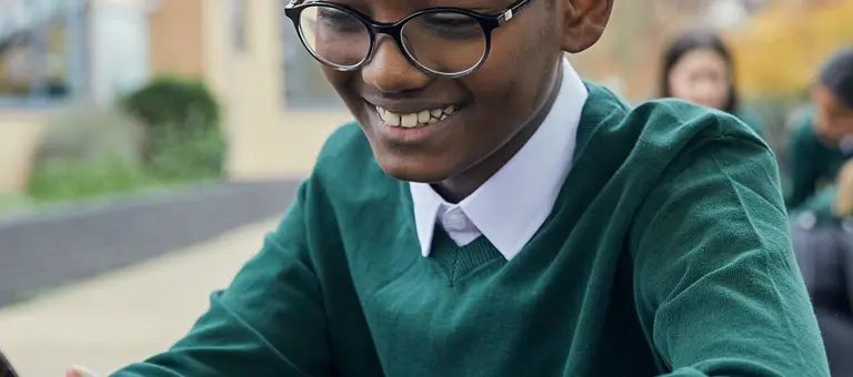Schoolboy looking at his smartphone