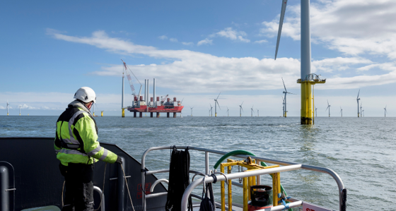 Man on a boat looking at an offshore facility