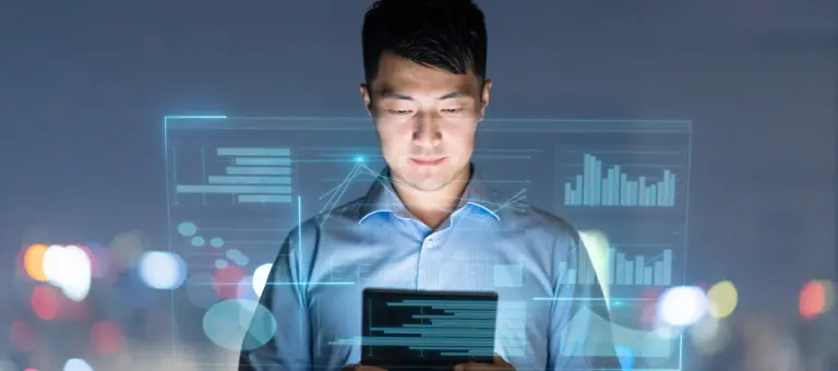 A man looking at a tablet with graphics overlay