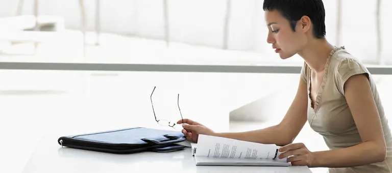 A woman reading a report