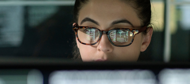 Woman working behind a screen in an office