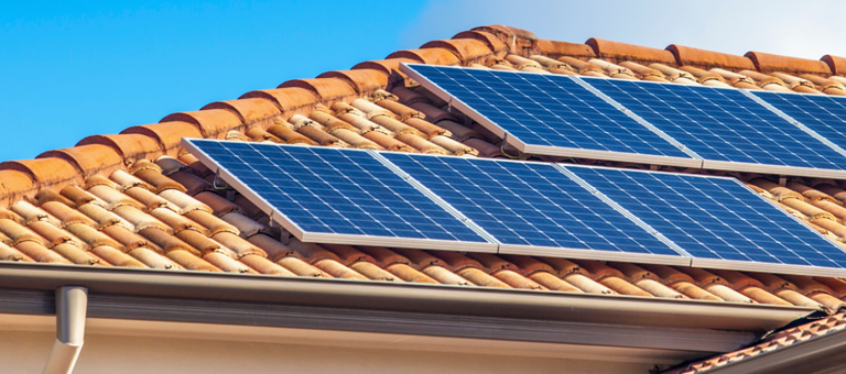 Solar panels attached to a tile roof