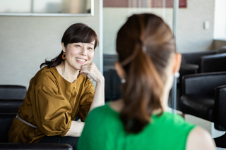 A smiling businesswoman in discussion with a client