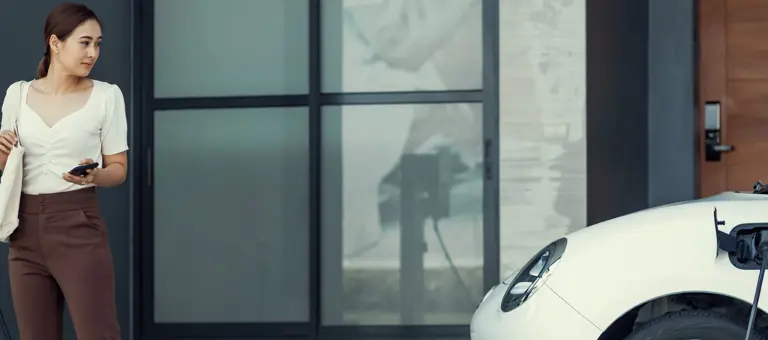Woman charging an electric car