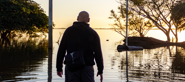 Man looking at a flooded landscape