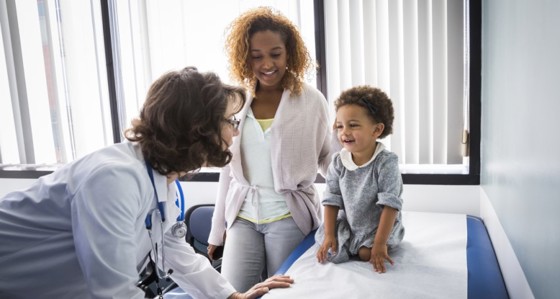 doctor attending to parent and child