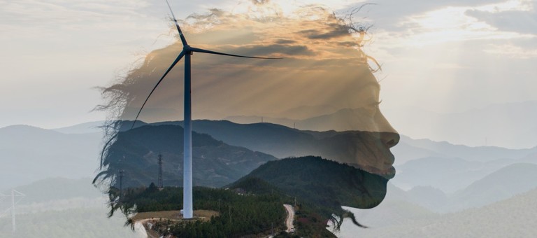 A woman's head superimposed over a wind turbine and hills