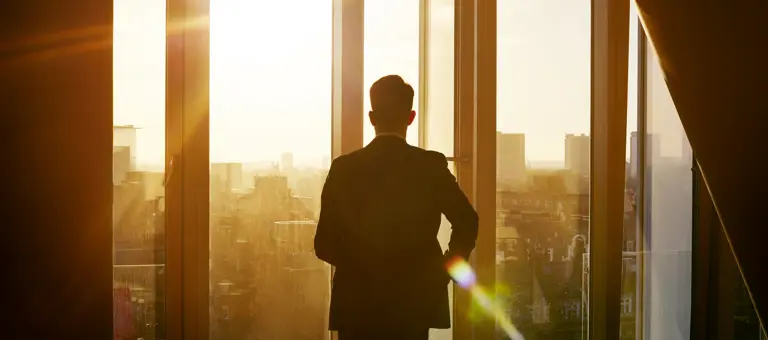 Man looking out of office window