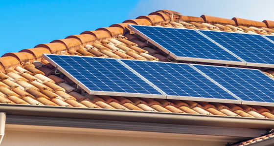 Solar panels attached to a tile roof