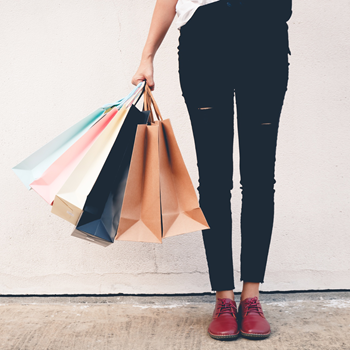 A customer holding shopping bags