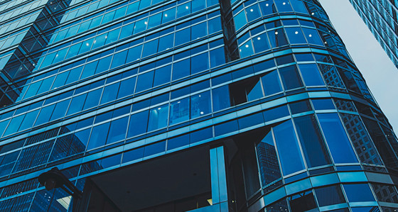 Looking up at modern glass-fronted buildings