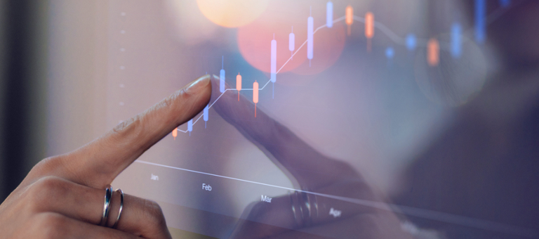 Finger touching a screen that is displaying a graph