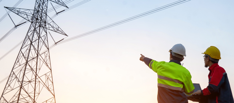 Workers pointing at a pylon