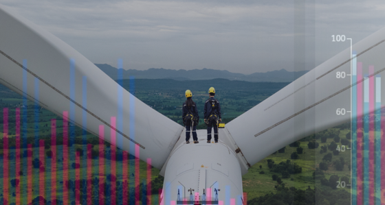 Two workers on top of a wind turbine