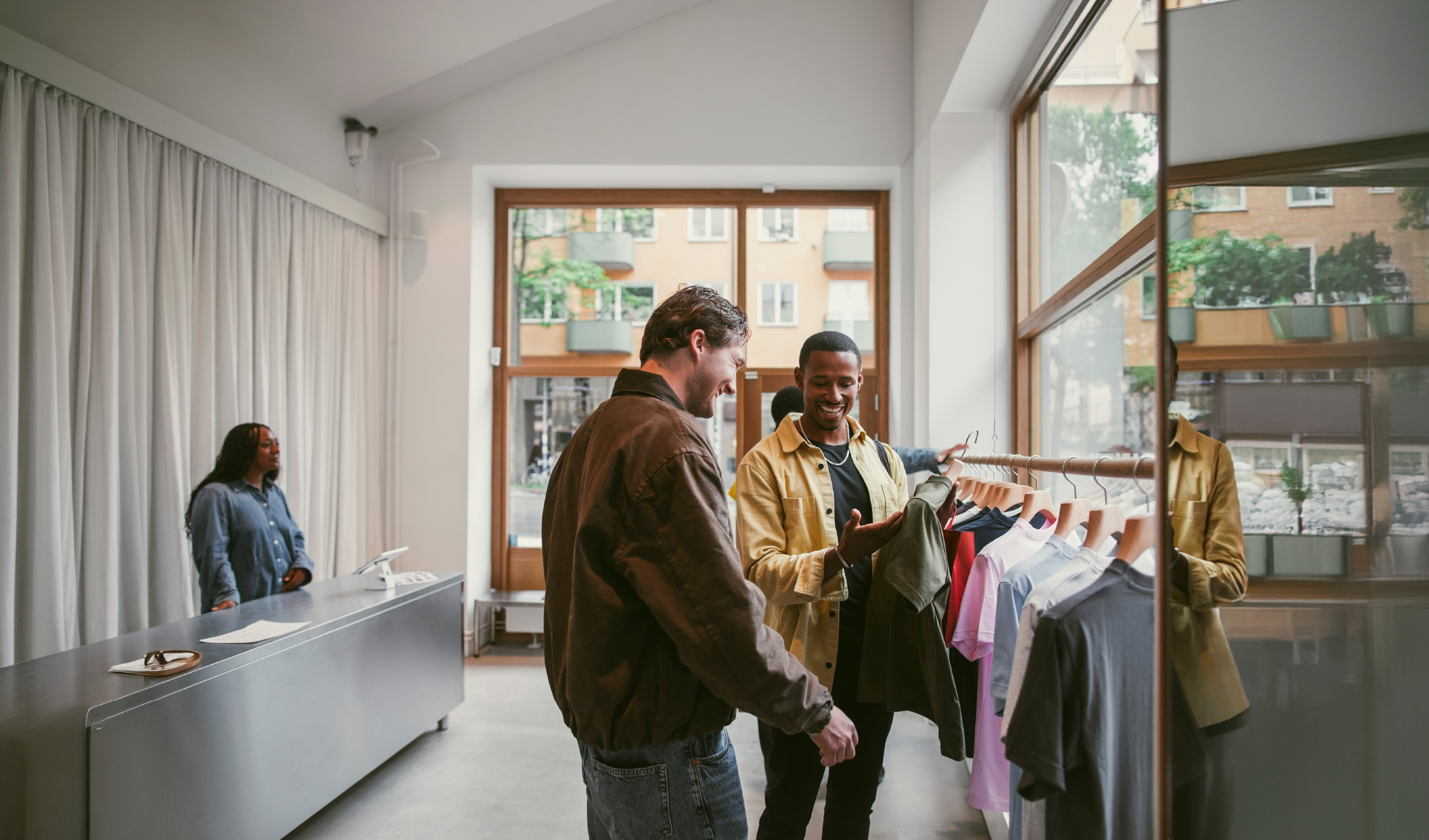 Men looking at clothing in shop