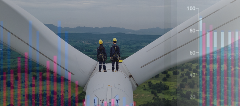 Two workers on top of a wind turbine