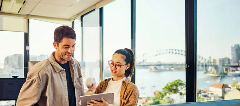 Two people looking at a tablet in a Sydney office