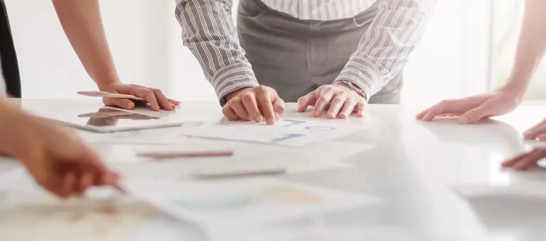 People around a table looking at documents